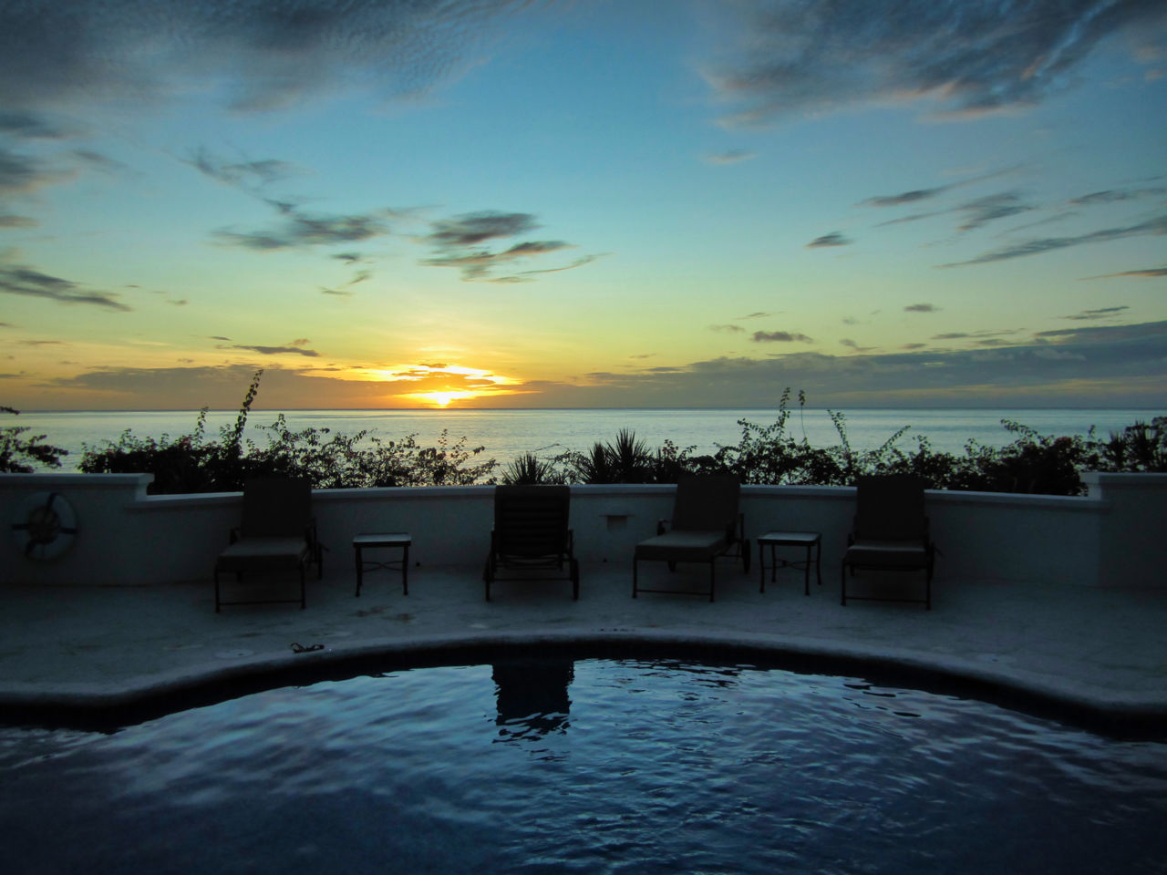 Sunset over the villa's pool