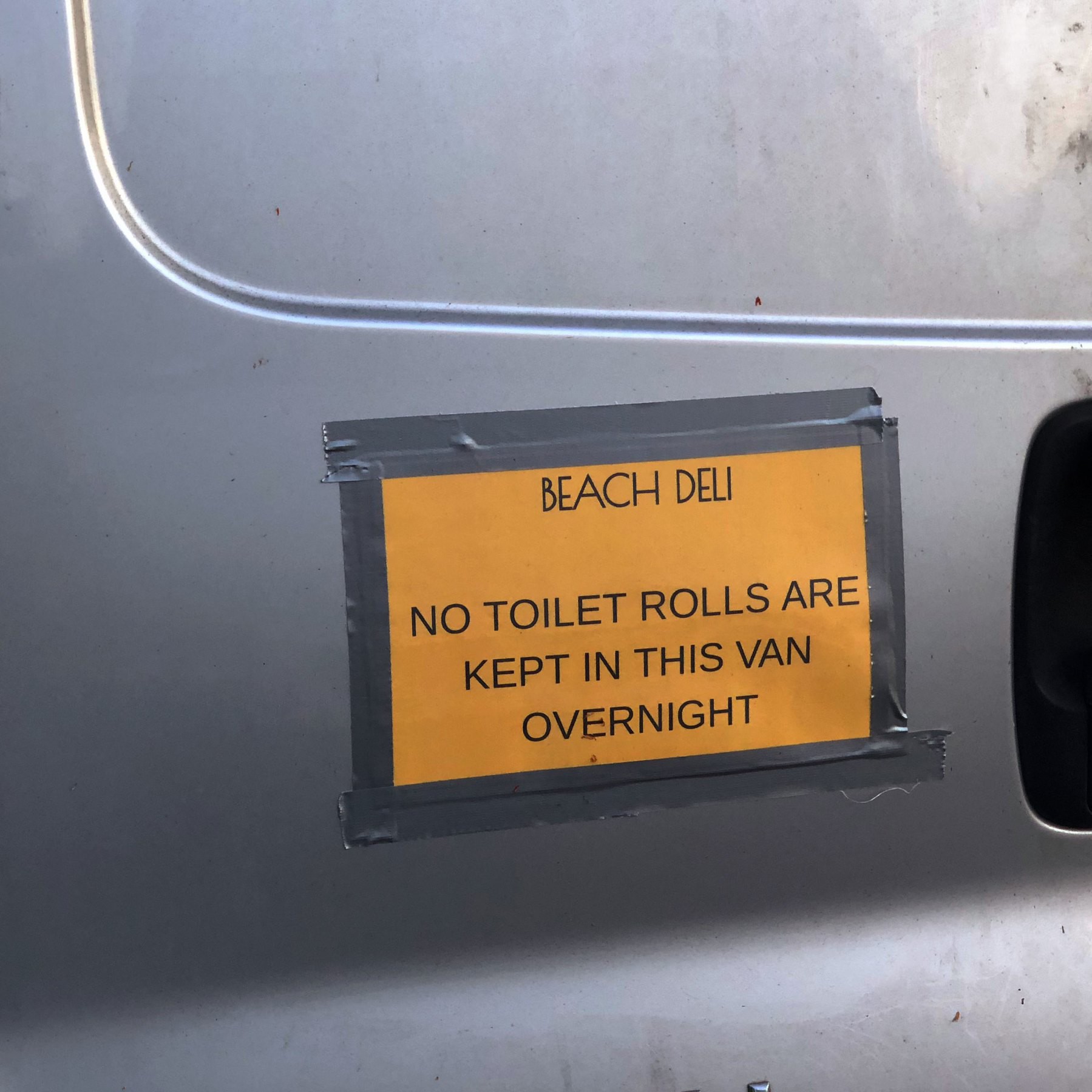 A sign on a van saying that no toilet rolls are stored there overnight. 