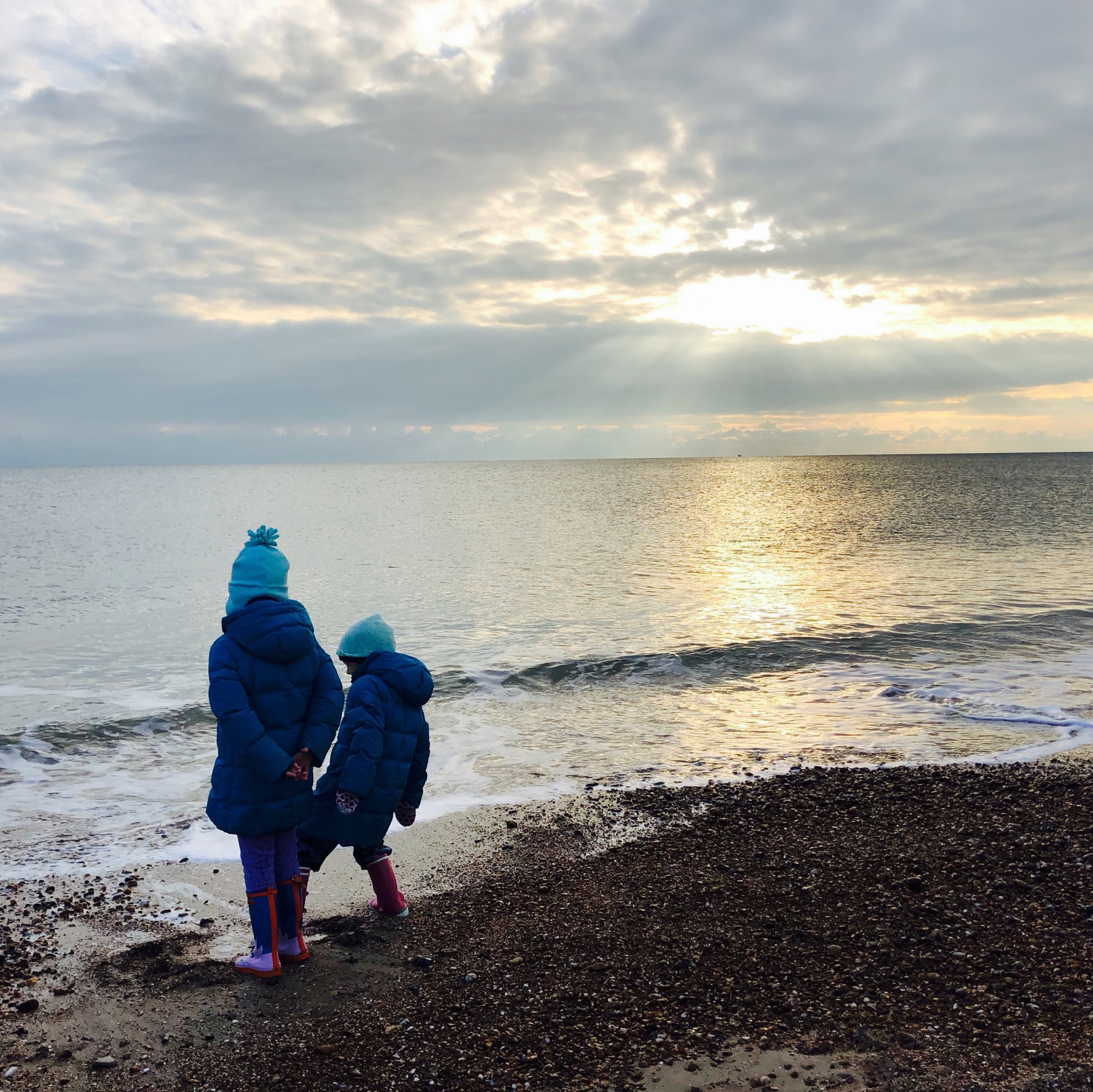 Two girls on a winter shoreline