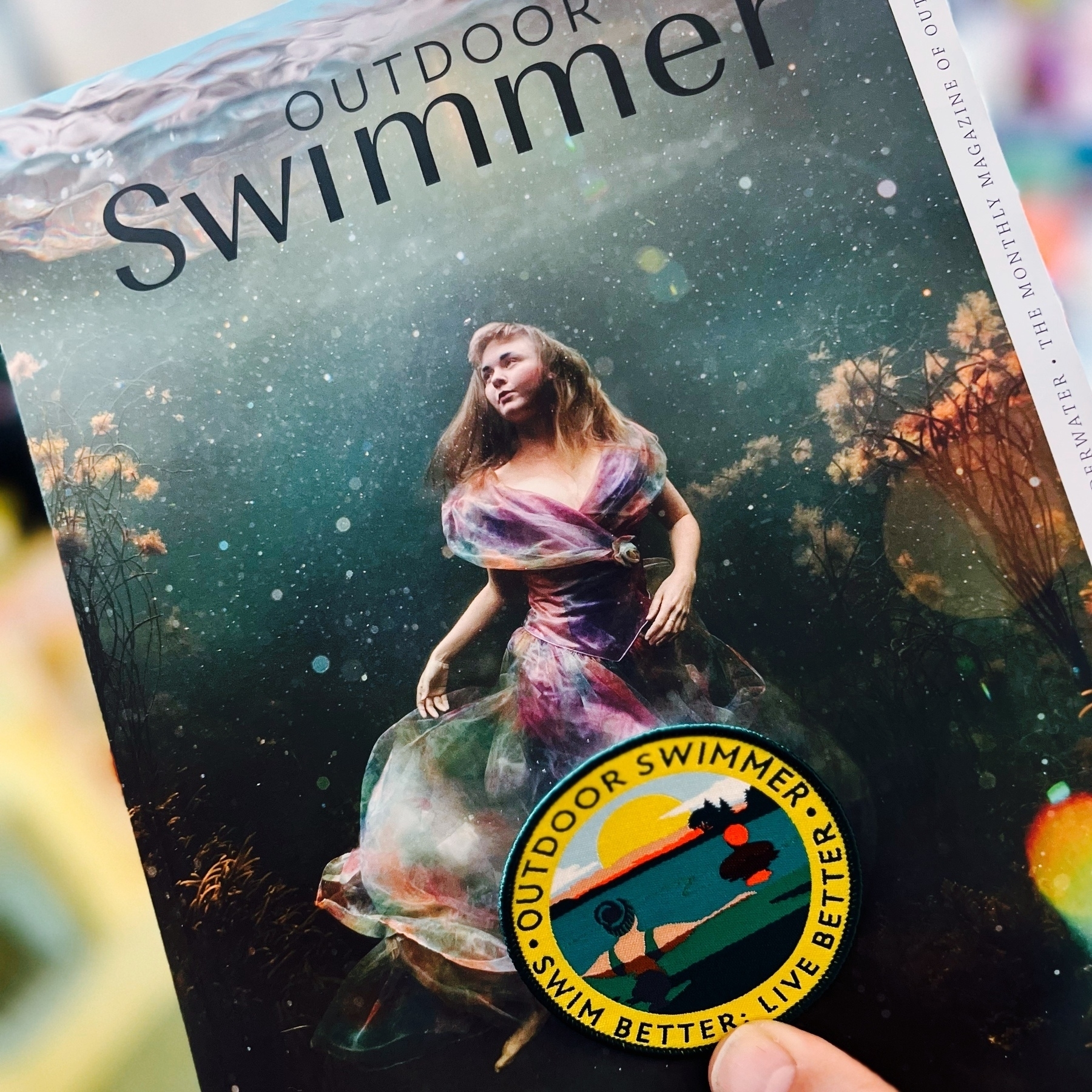 A subscriber patch and the latest copy of Outdoor Swimmer magazine. 