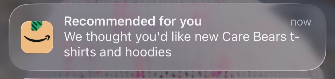 A notification from a shopping app recommends new Care Bears t-shirts and hoodies.